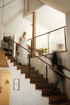 Modern staircase with white walls and wooden steps captured in motion blur sequence.