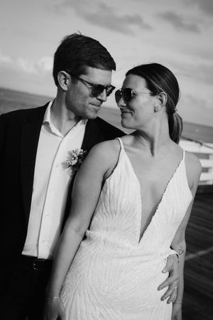 Black and white wedding portraits showing intimate moments with sunglasses and formal attire.