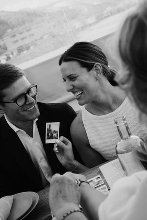 Black and white candid photos capture tender moments between a couple during their wedding celebration.
