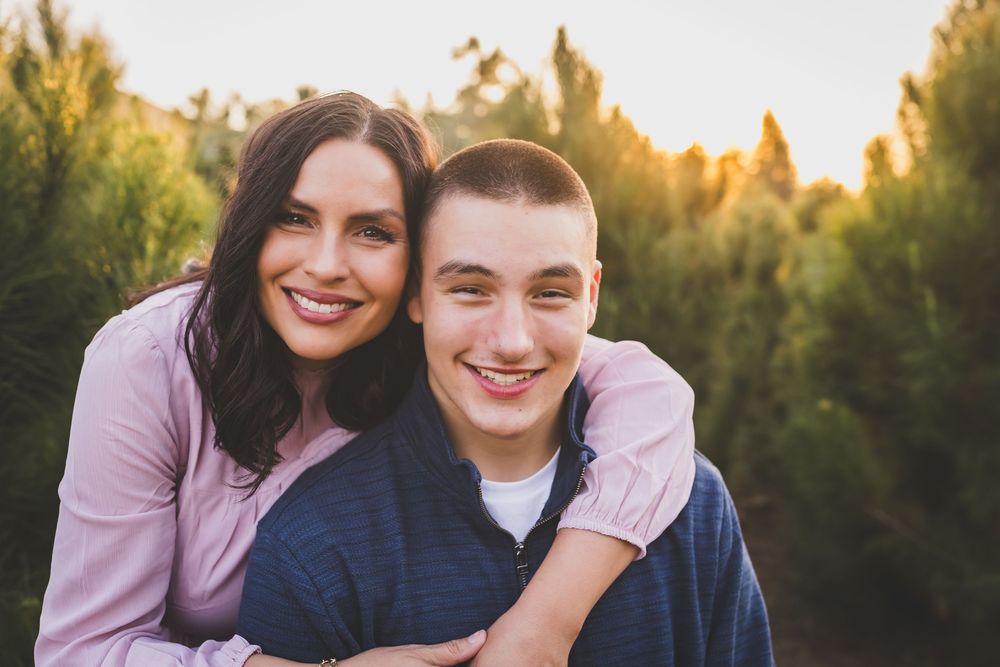 A series of outdoor family portraits taken at sunset with golden light filtering through trees in the background.