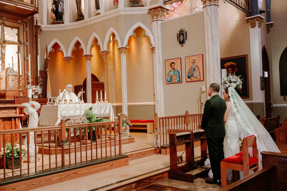 A panoramic view of a church interior with ornate architecture, wooden pews, and religious artwork on display.