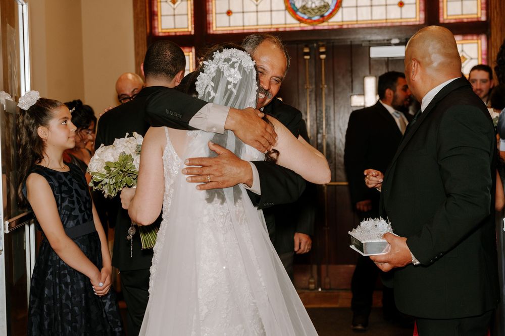 Wedding party gathering in a church with joyful interactions and celebrations.