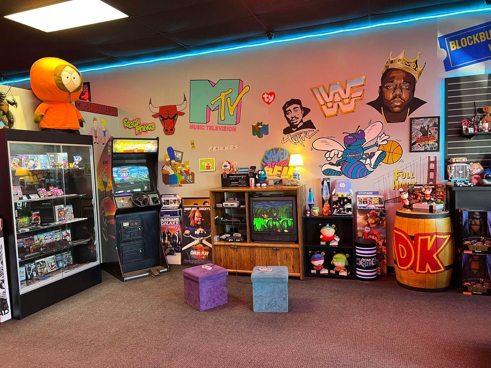 Toy store interior featuring colorful character murals, display shelves, and neon lighting.