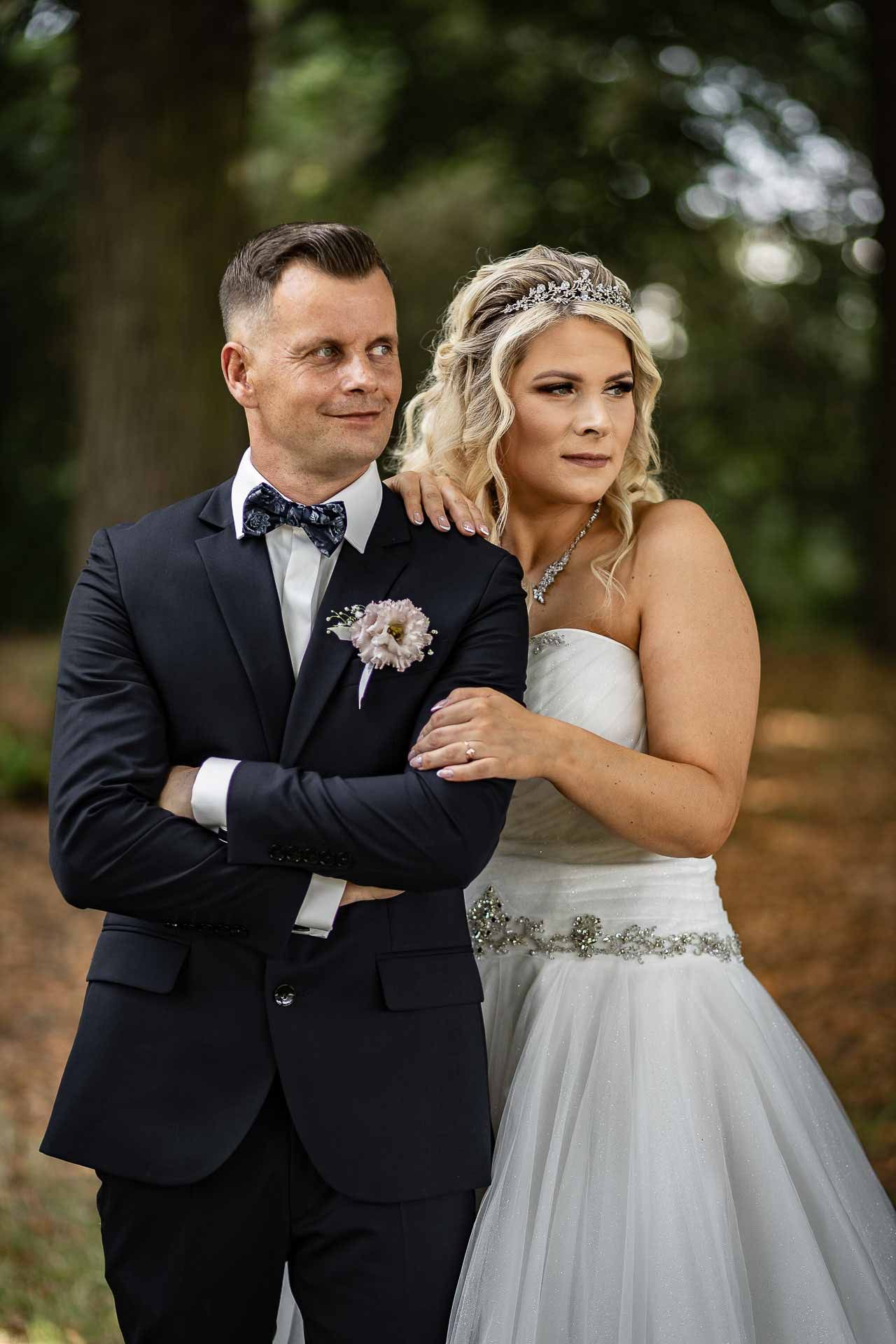 Elegant wedding portraits captured outdoors showing tender moments between the newlyweds.