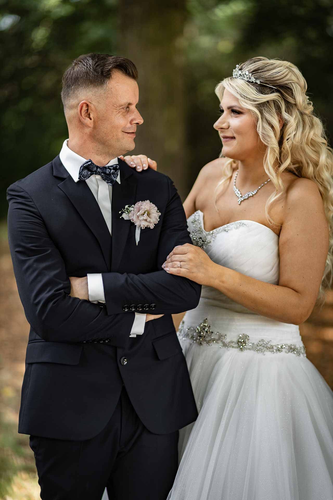 Intimate outdoor wedding portraits showing tender moments between the newlyweds.
