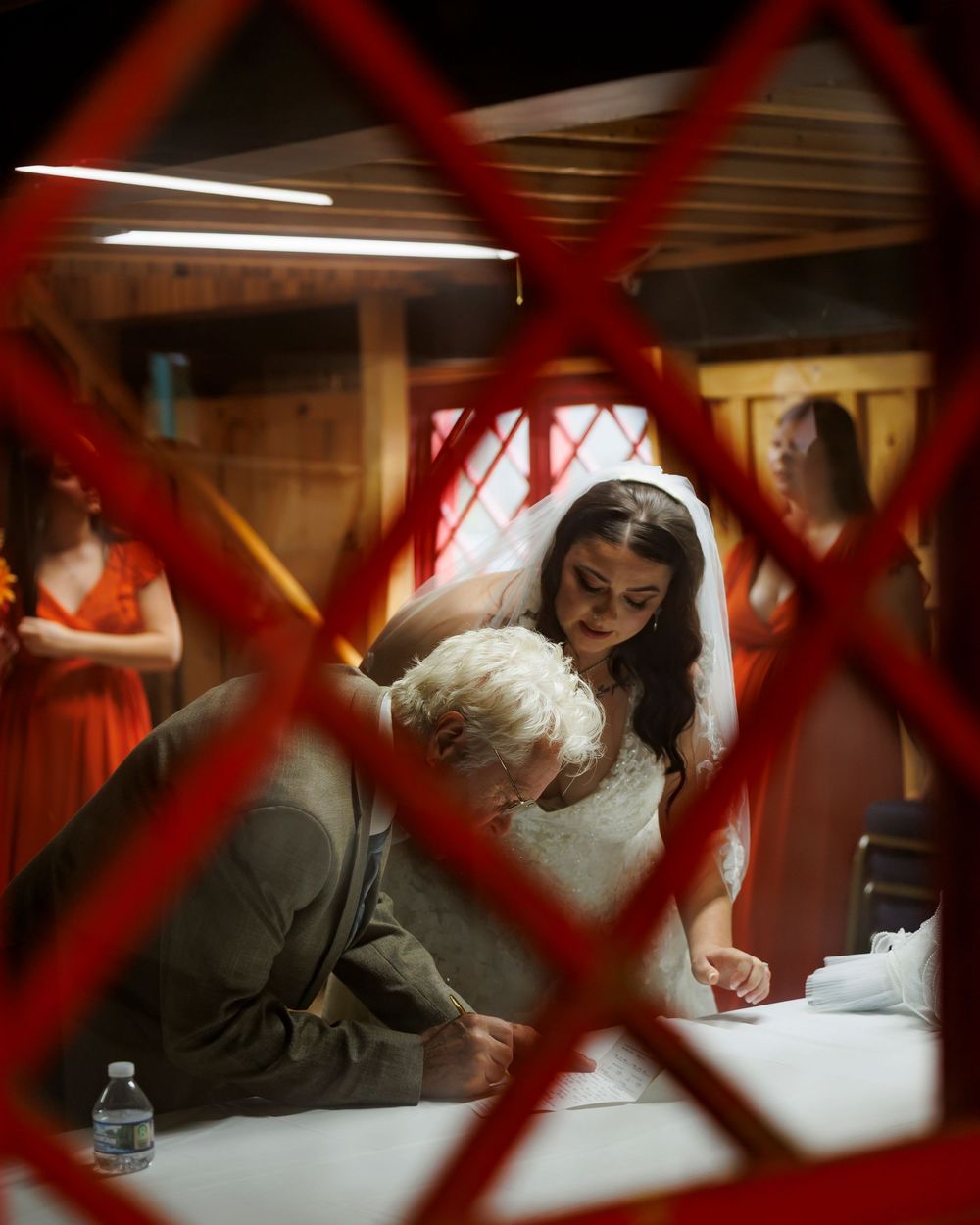 A document signing scene through red criss-crossed lines.