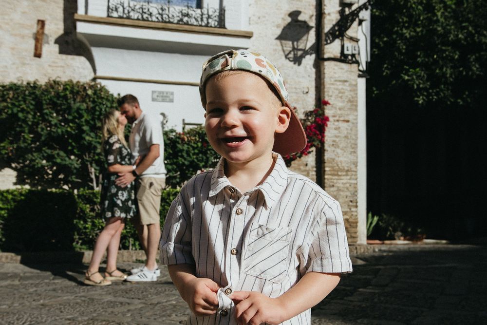 A series of candid outdoor family moments captured during a summer gathering in front of a brick building.