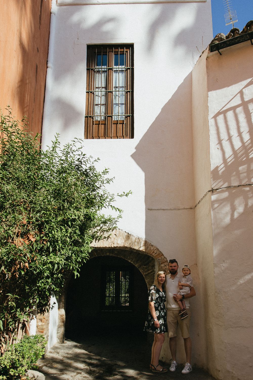 A sequence of photos showing a charming Mediterranean alleyway with white walls and wooden window frames in sunlight.