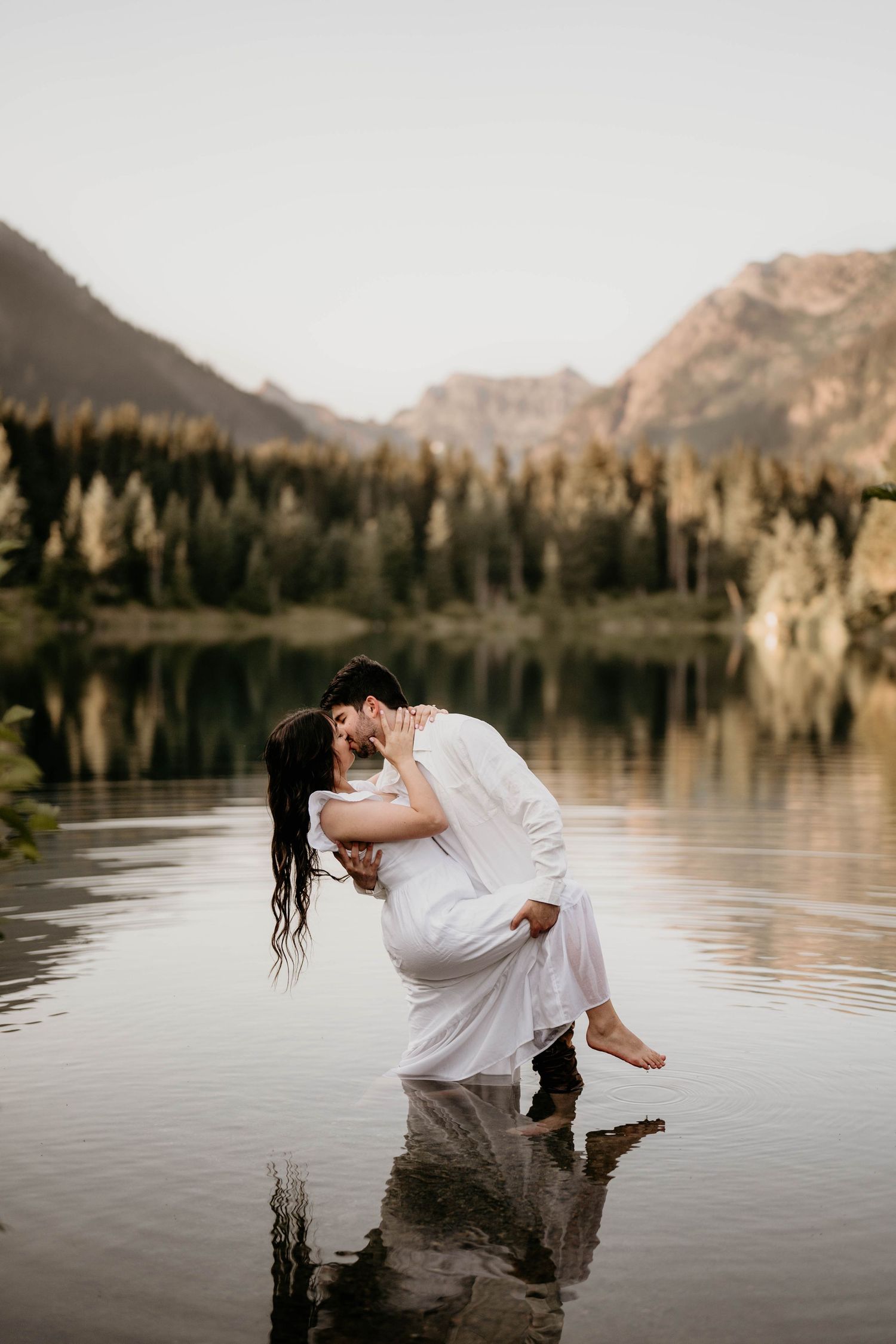 New engaged couple posing in the water at Gold Creek pond in Washington