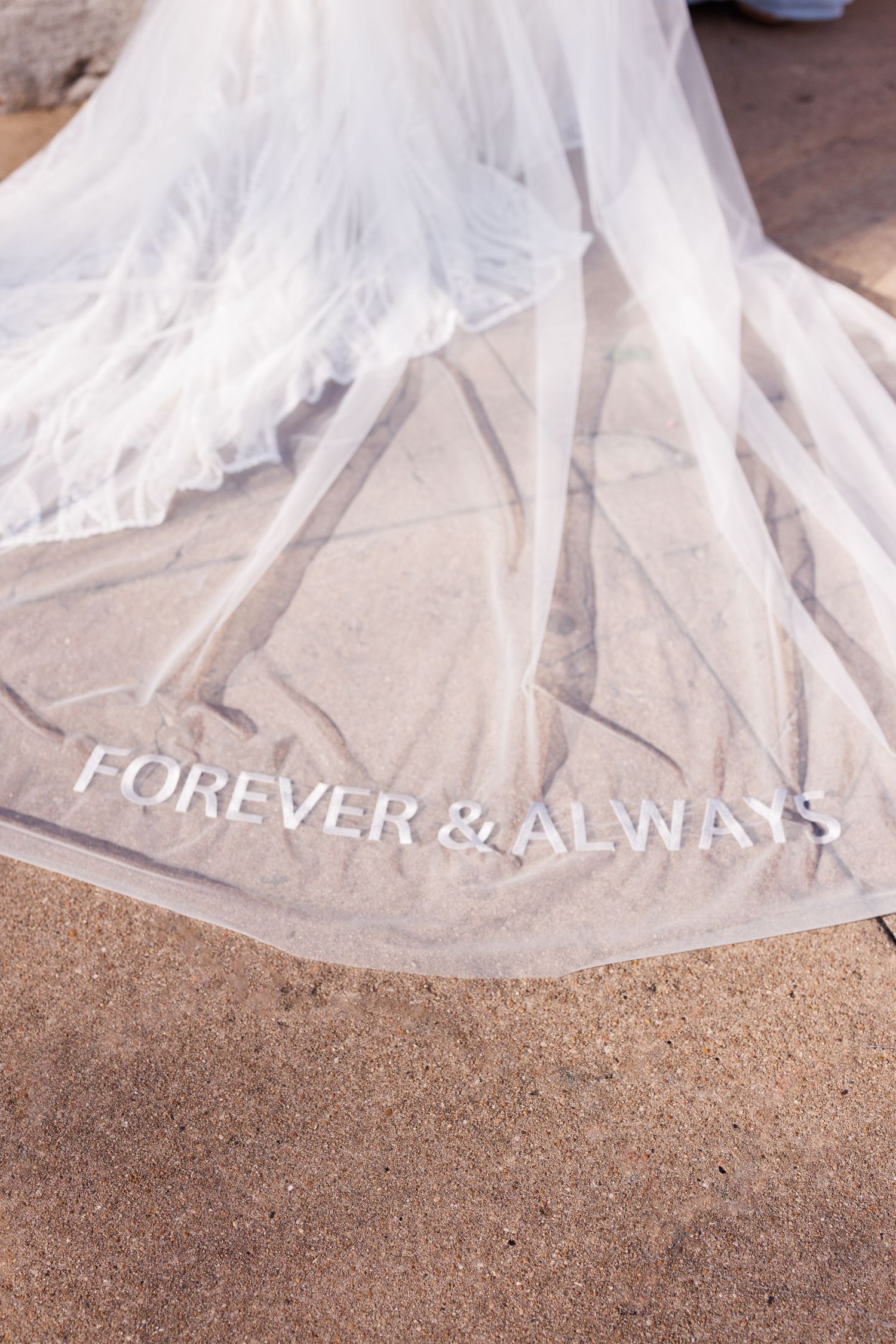 White wedding dress veil trailing on the ground with text overlay.