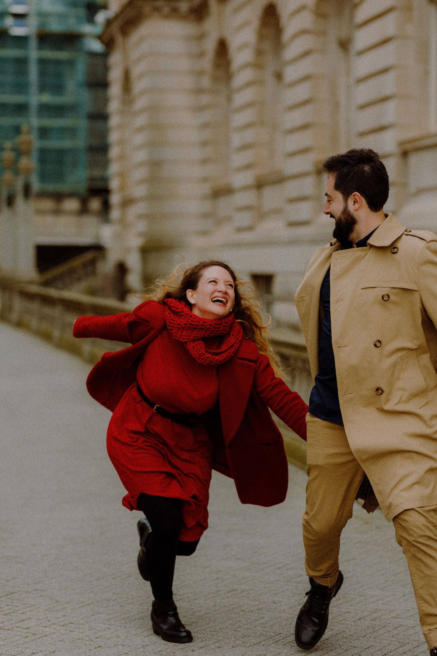A couple in red and beige outfits share an intimate kiss in a series of romantic close-up photos.