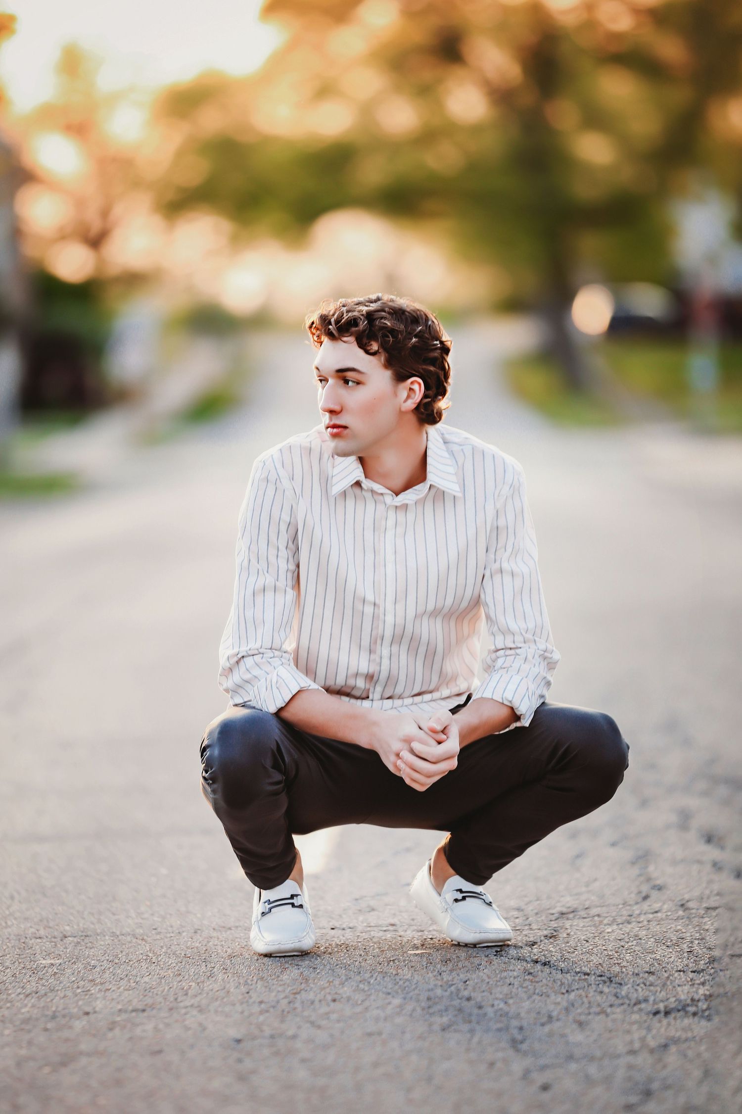 Young person in striped shirt crouching on street with blurred autumn background.

Best teen's photographer in Illinois