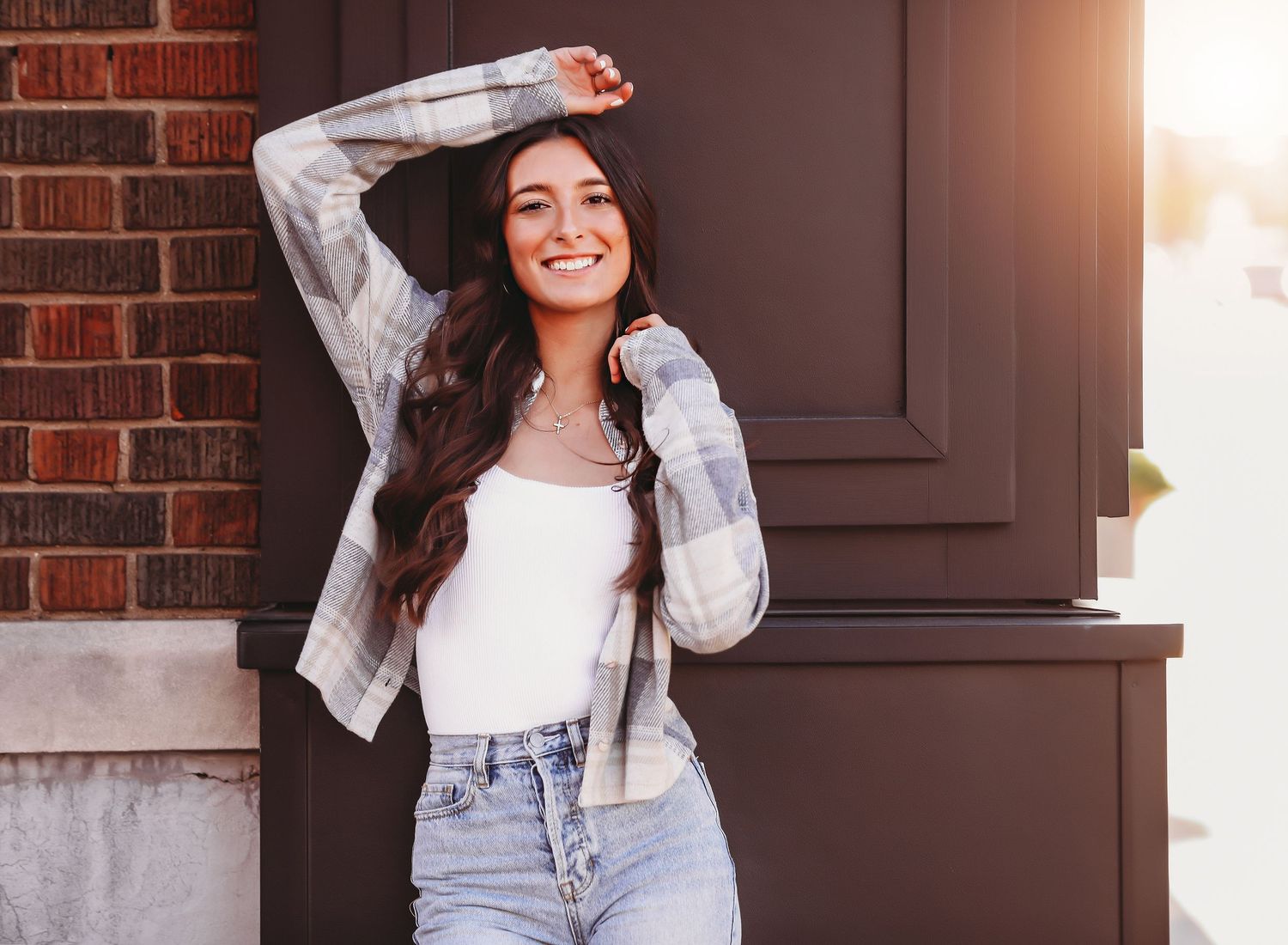 Portrait against brick wall showing person in white sweater and light denim.
Best photographer in Illinois