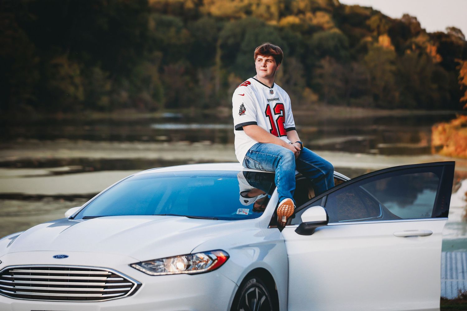 Casual portrait of someone sitting on top of white car near water.
Best photographer in Illinois
