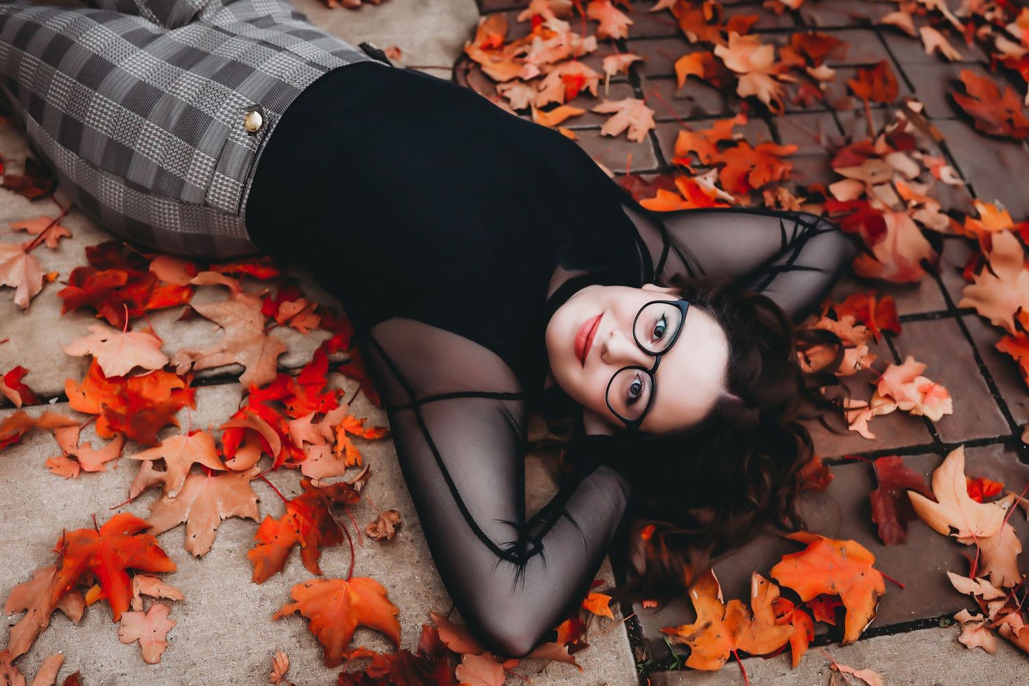 Person lying among scattered orange autumn leaves wearing plaid clothing.

Best photographer in Illinois