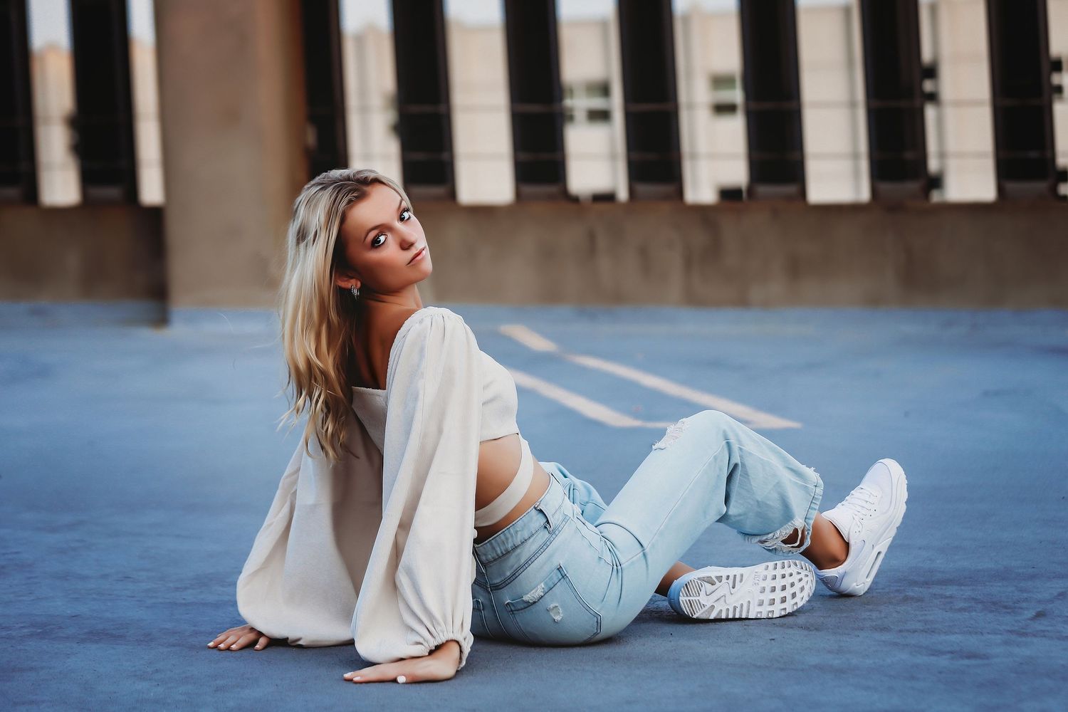 Person in casual wear lounging on blue surface wearing white sneakers.

Best senior photographer in Illinois
