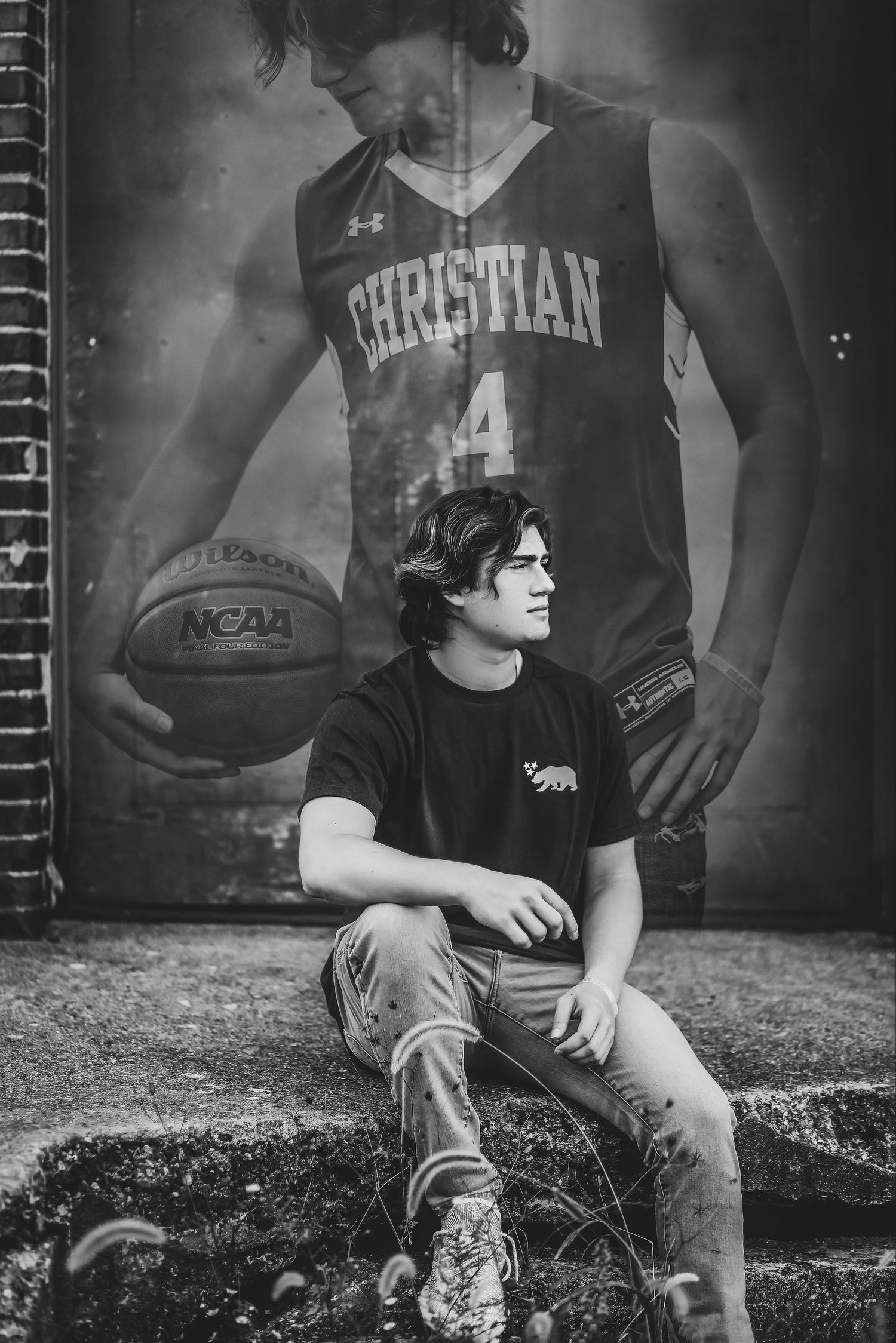 Person sitting beneath large basketball poster in black and white composition.
Best teen's photographer in Illinois