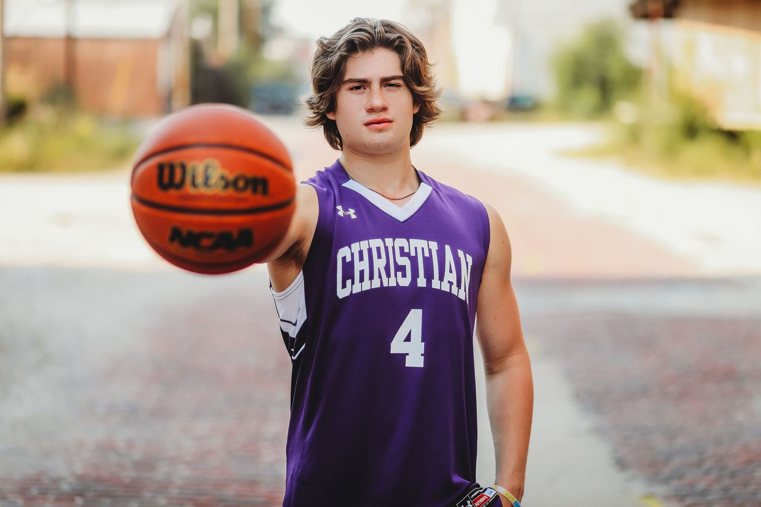 Basketball player wearing purple jersey holds ball during outdoor practice.
Best teen photographer in Illinois