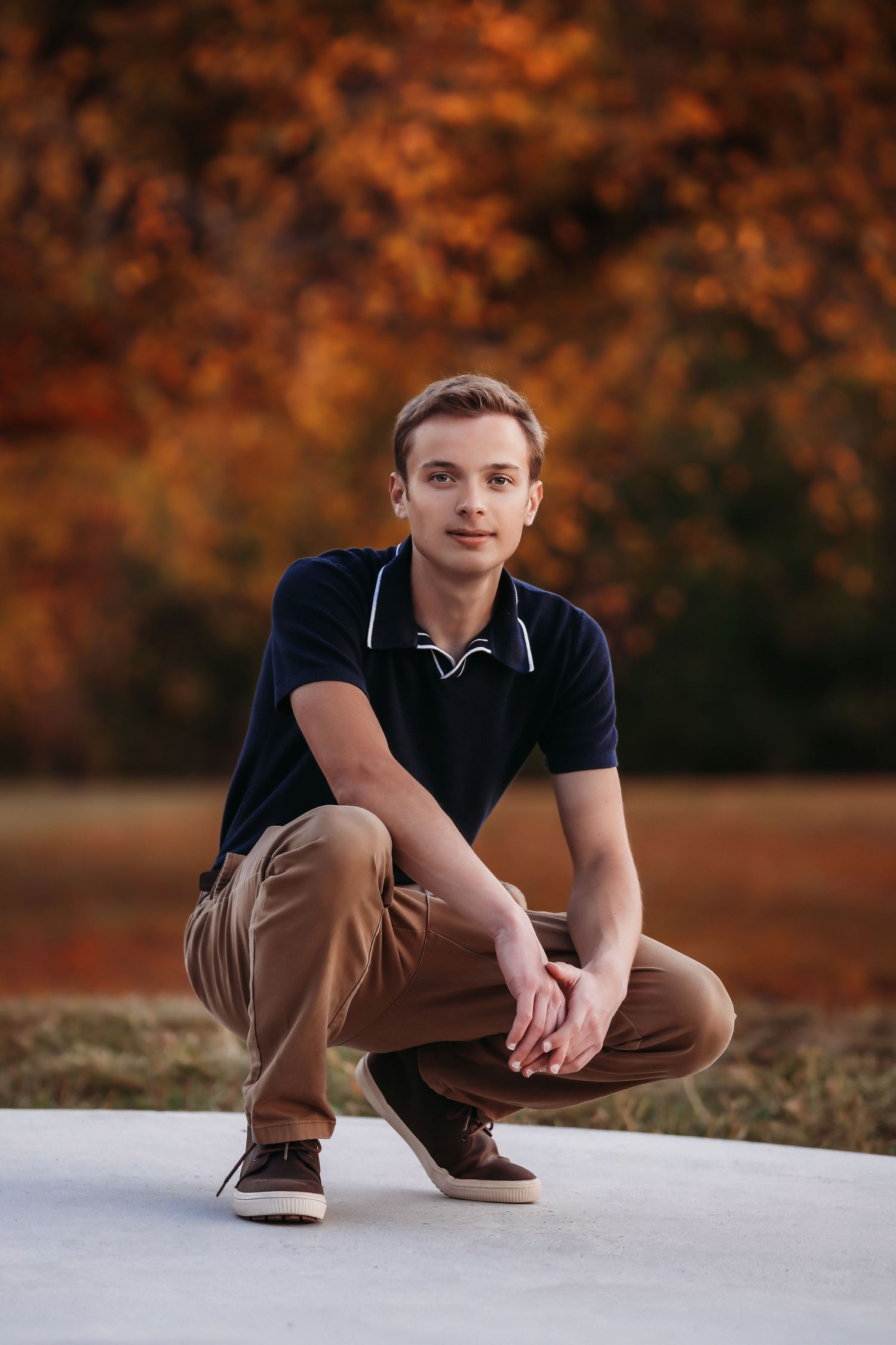 Person in navy polo and khaki pants crouching on white surface during autumn.

Best photographer in Illinois