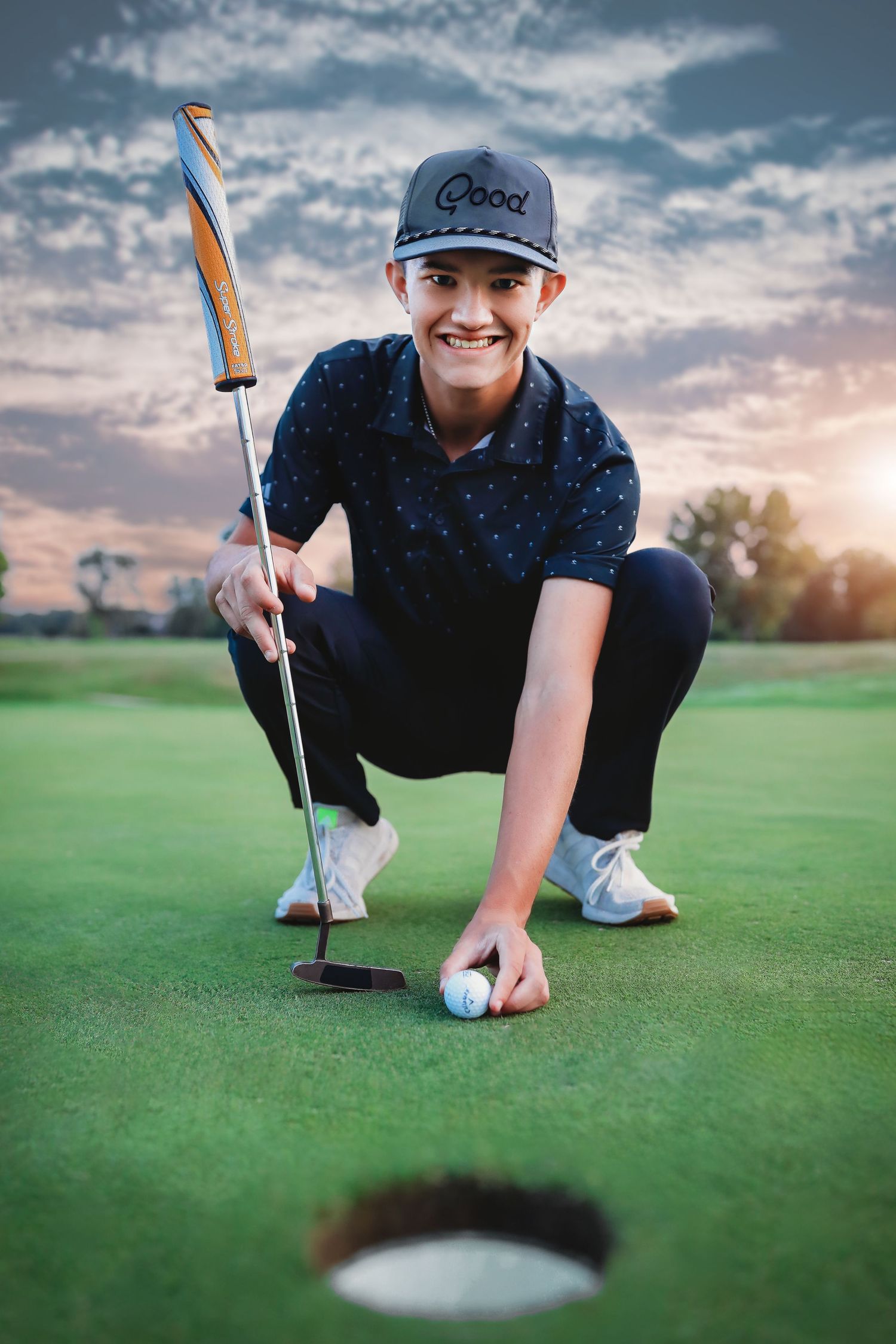 Golfer in baseball cap lining up putt on green during sunset.
Best photographer in Illinois
