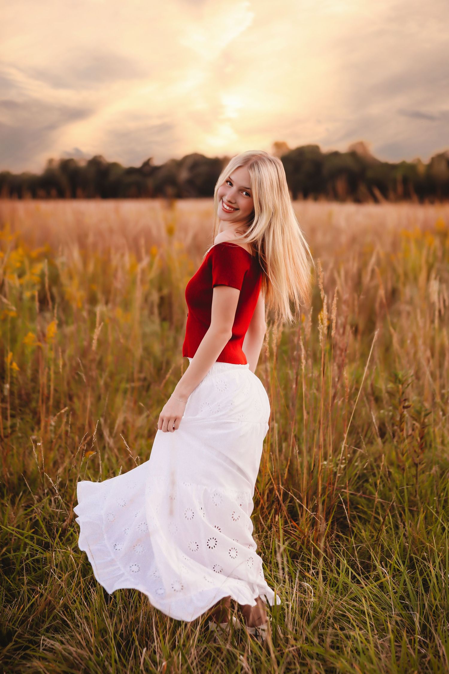Person in red top and white dress twirling in a golden field at sunset.
Best photographer in Illinois
