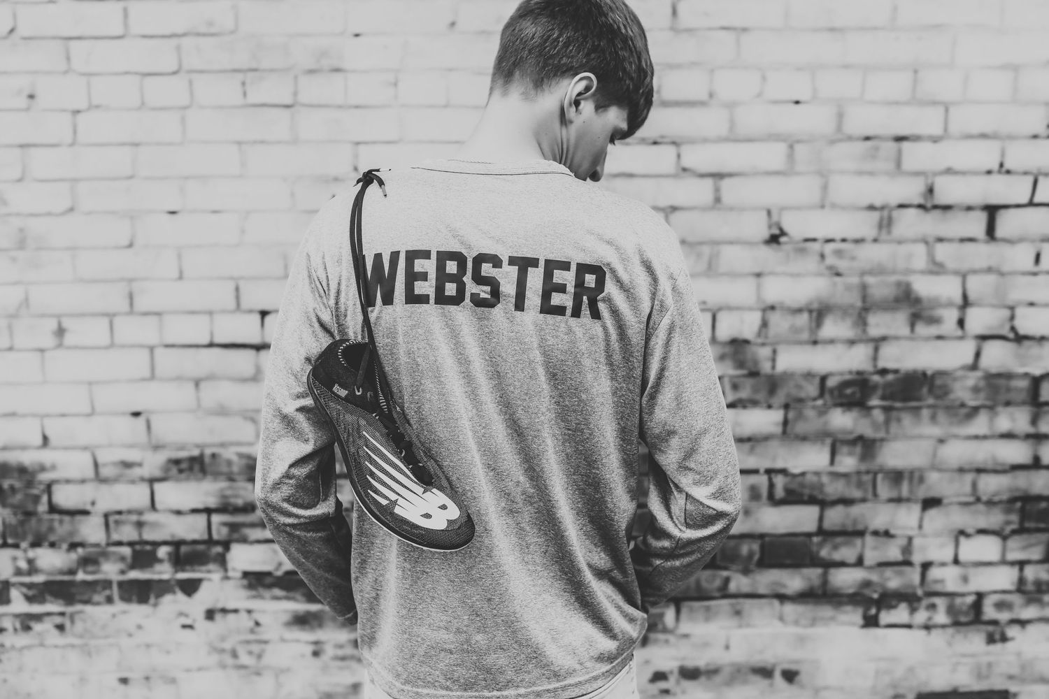 Black and white photo showing a group of men in Webster jerseys standing against a brick wall.
Best teen's photographer in Illinois