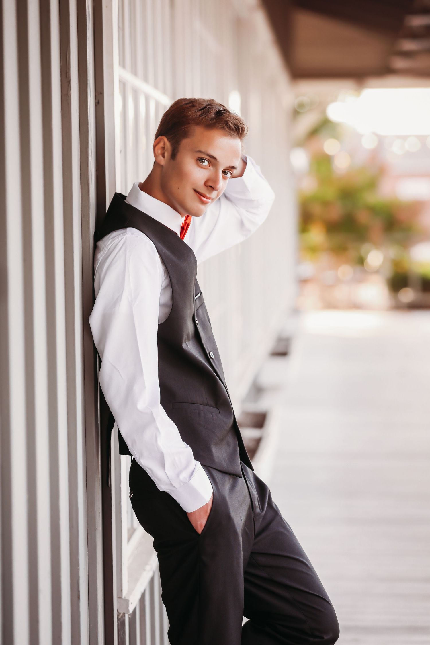 Formal portrait against white columns showing person in black vest and white shirt.
Best photographer in Illinois