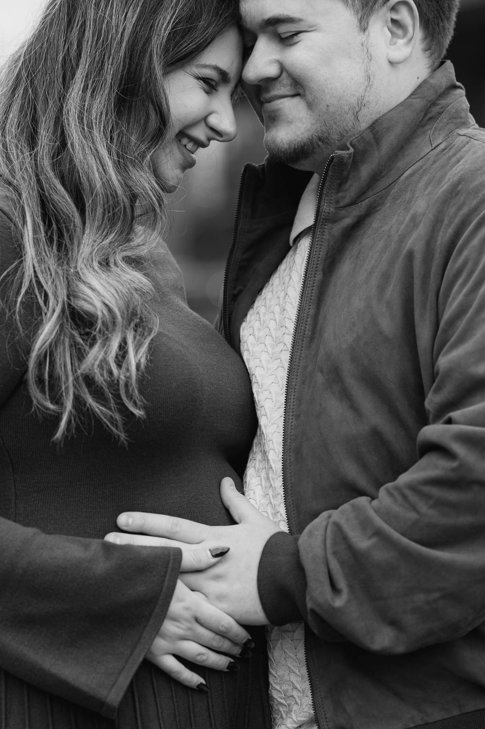 A romantic black and white photo sequence showing a couple in an intimate embrace with gentle expressions and tender moments.