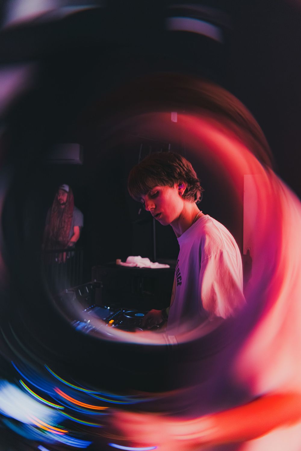 Abstract motion blur photography creates swirling patterns of red, blue and purple light in a dark setting.