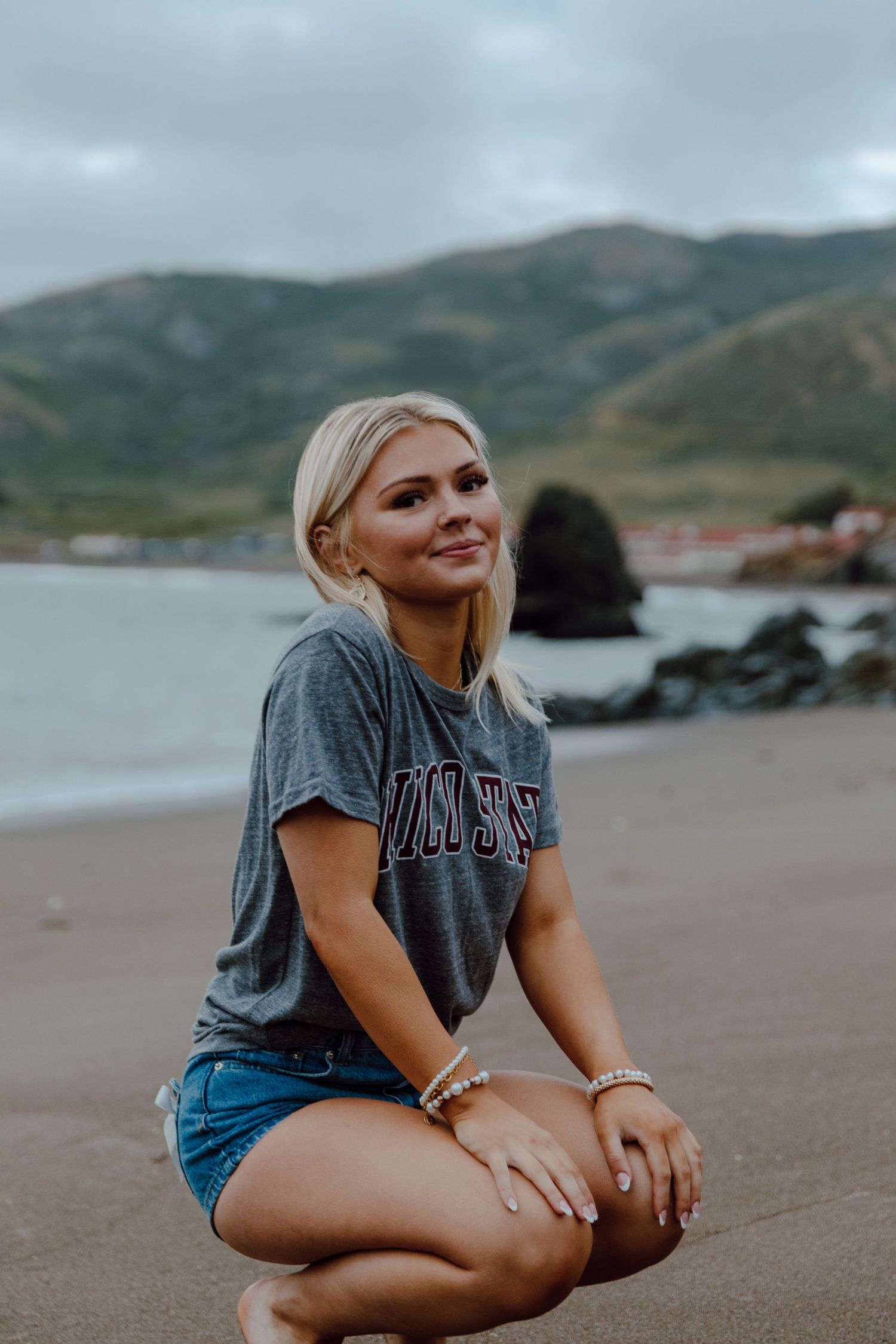 Senior wears a Chico State shirt while posing for her graduation photos. Taken by a Bay Area Grad Photographer