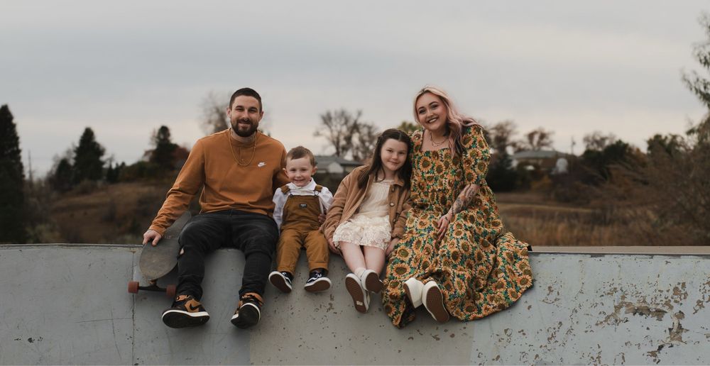 Family portrait session in a natural autumn setting with golden light.