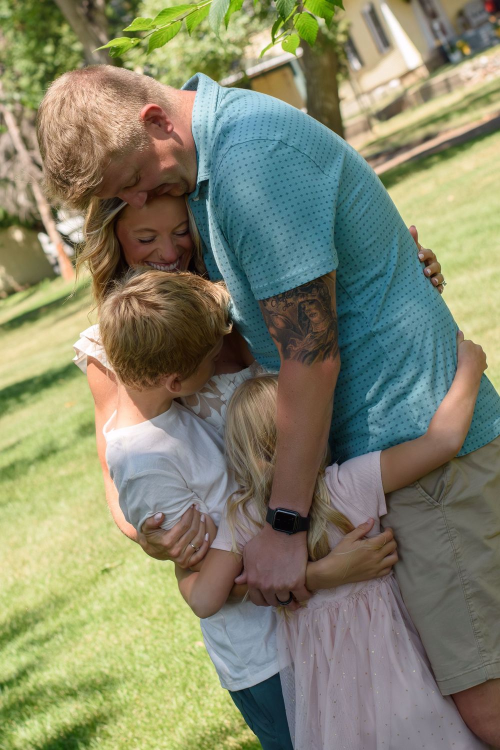 Sweet embraces and tender moments captured in a sunny park setting.