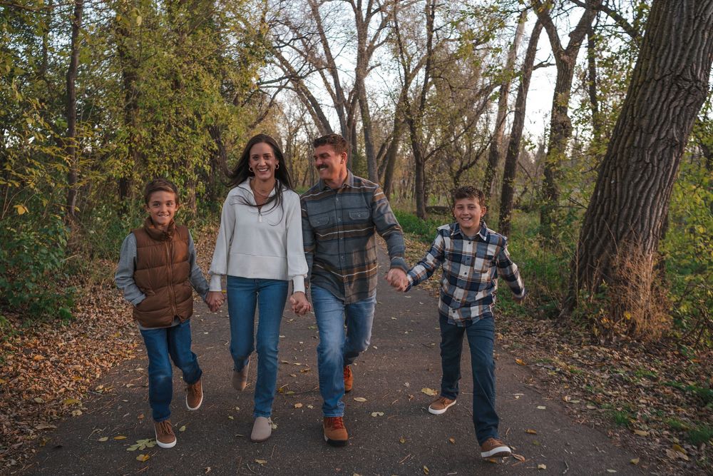 A sequence of playful walking poses on a tree-lined path during fall.