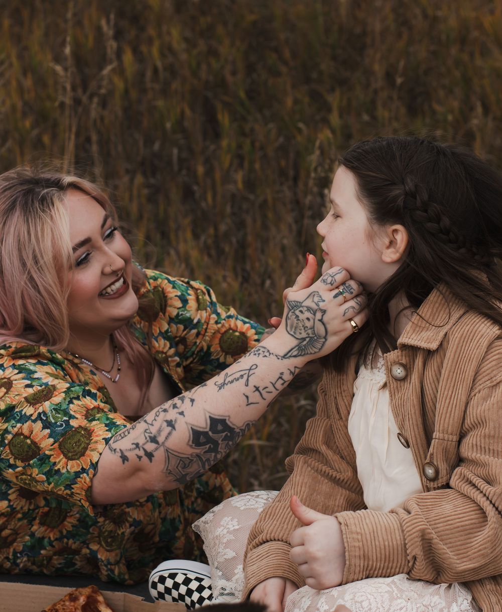 Candid family moments captured during an outdoor autumn photoshoot with warm lighting.