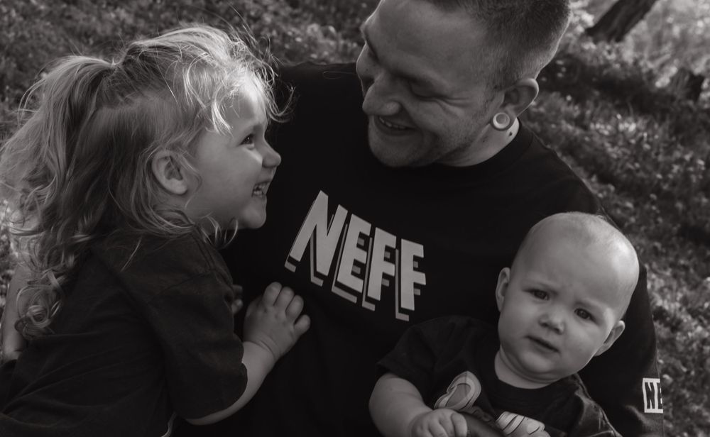 Candid black and white family portrait showing tender moments of connection.