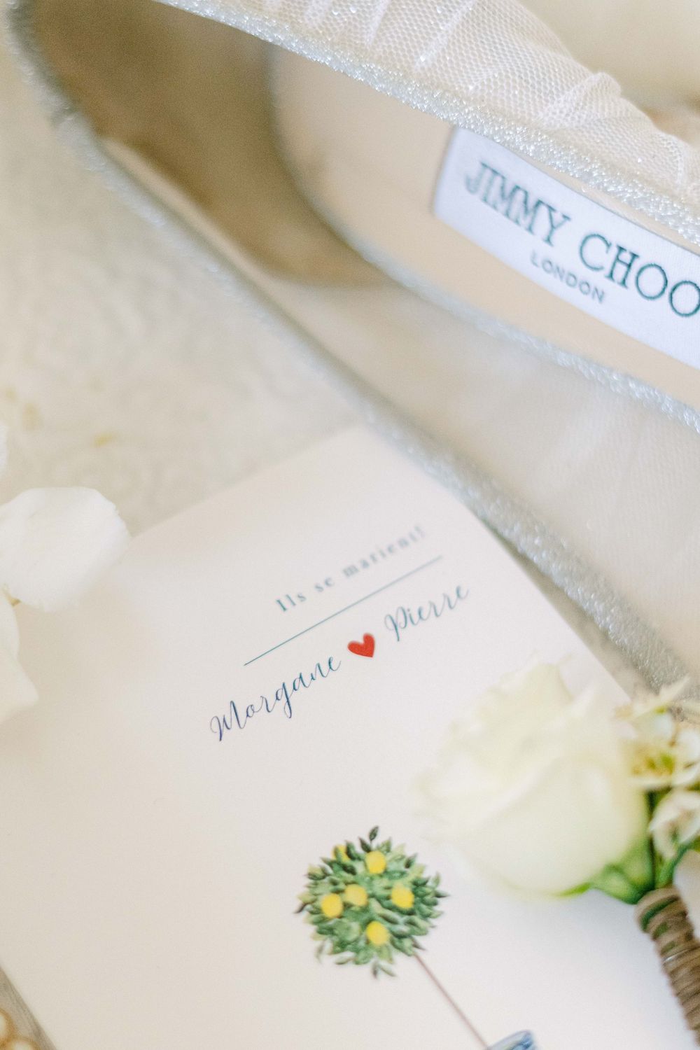Wedding invitation with elegant calligraphy and floral details on cream colored paper.