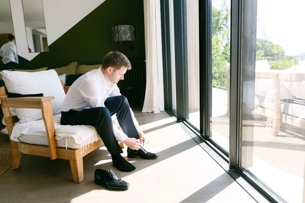 A sequence of photos showing someone sitting on a bench by large windows in different positions and angles.