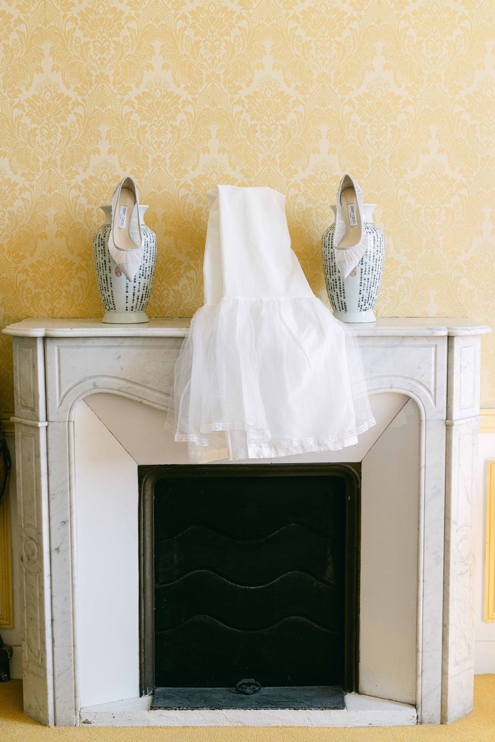 A sequence of photos showing a white cloth or veil gradually disappearing behind a decorative fireplace mantel.