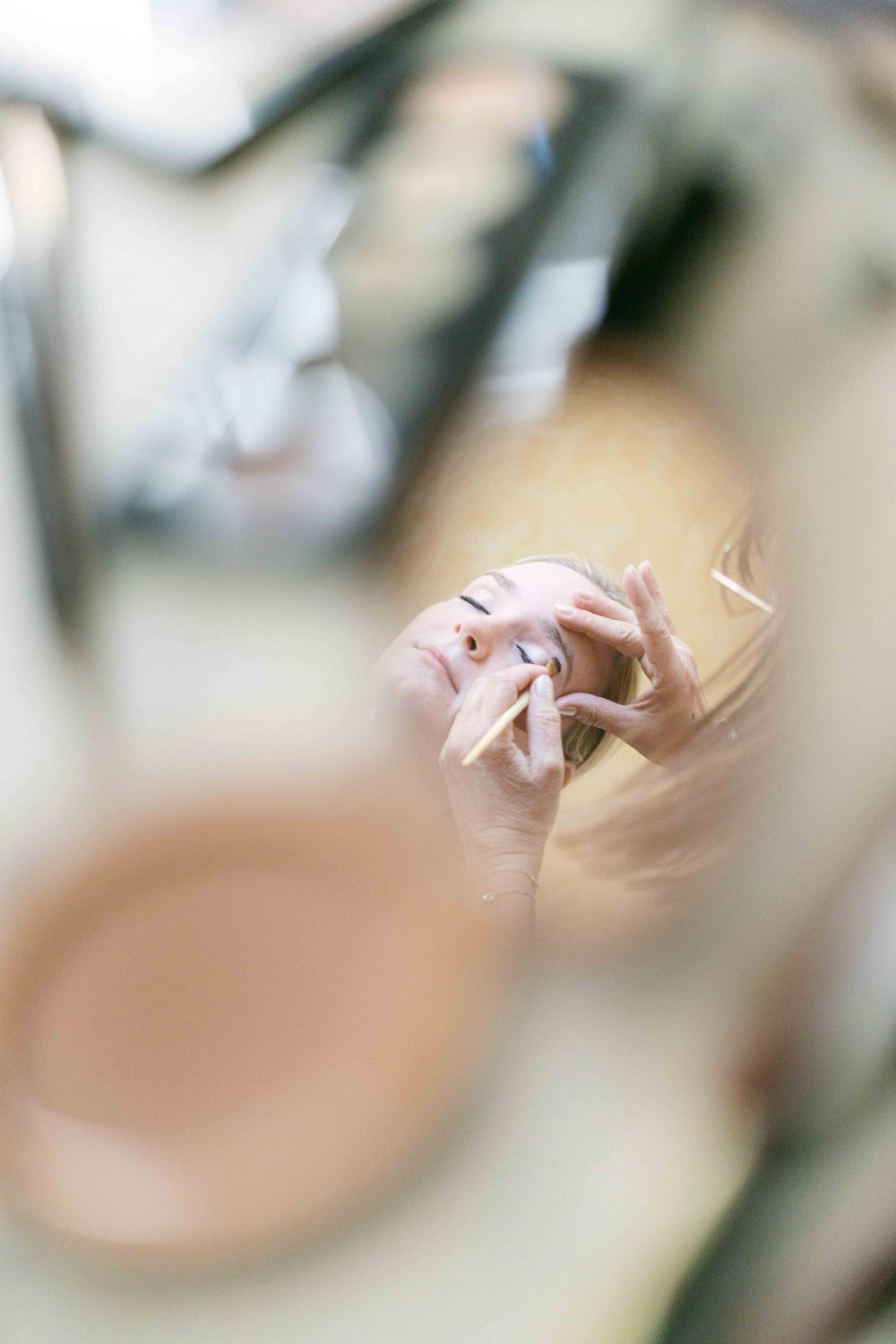 A soft focus artistic photo of pink and white origami paper cranes with blurred bokeh background effect.