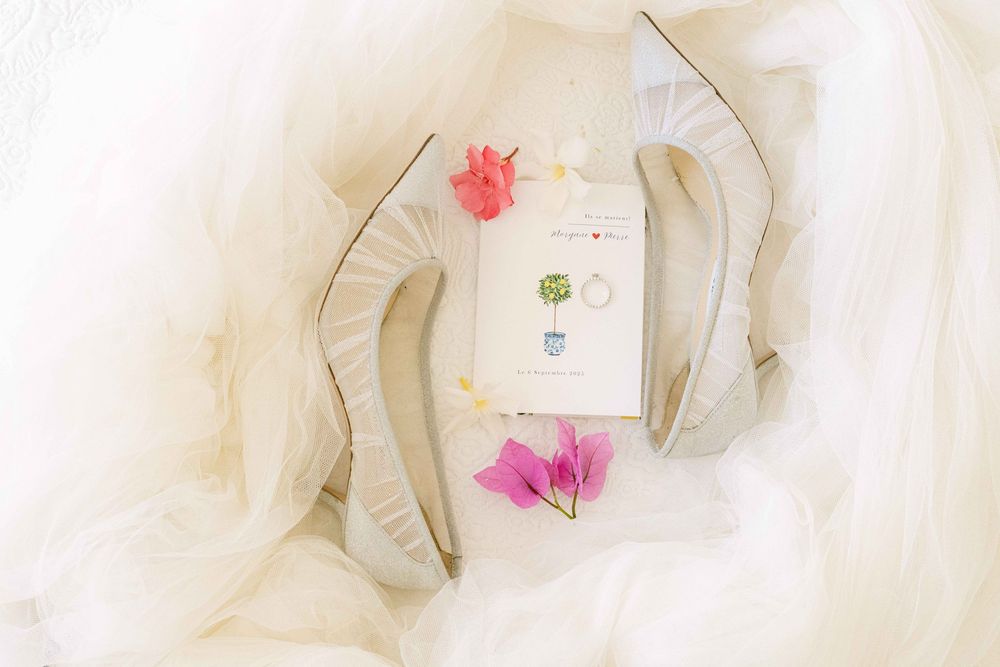 Delicate white tulle fabric with floral embellishments creates an ethereal texture and pattern.