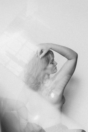 A series of artistic black and white photographs showing abstract human forms in ethereal poses against a light background.