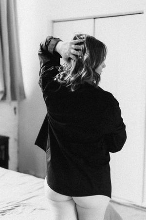 Black and white photo series showing a person in a dark hoodie sitting on a bed from behind.