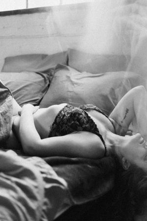 Black and white artistic photo series showing someone resting peacefully in bed with soft lighting and shadows.
