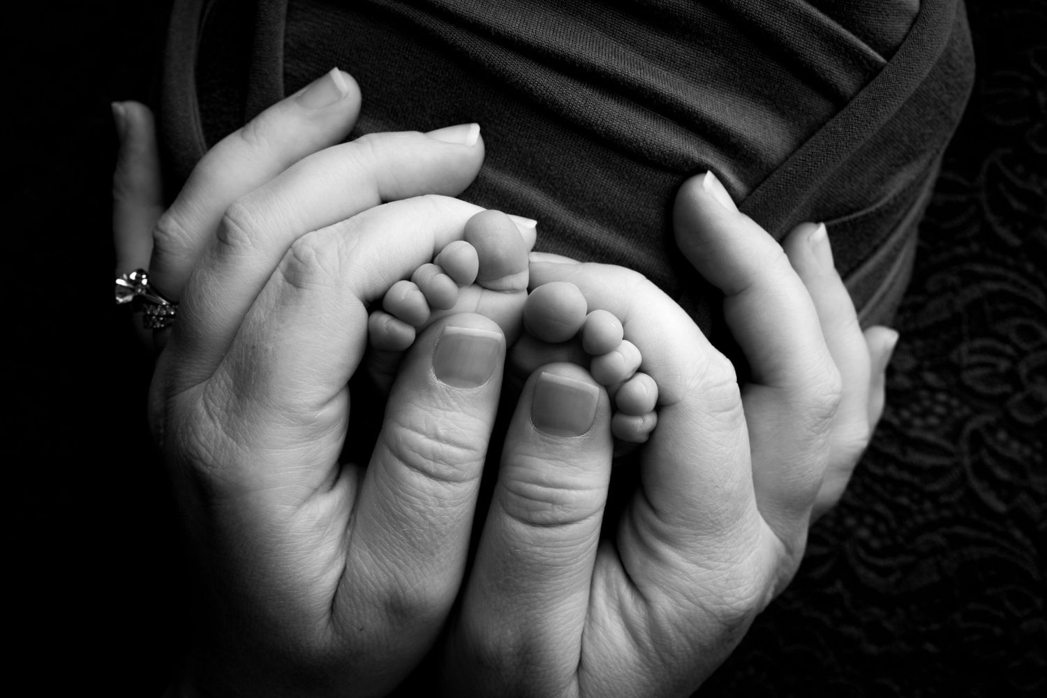 Black and white close-up photos of infant hands grasping and reaching in different positions.