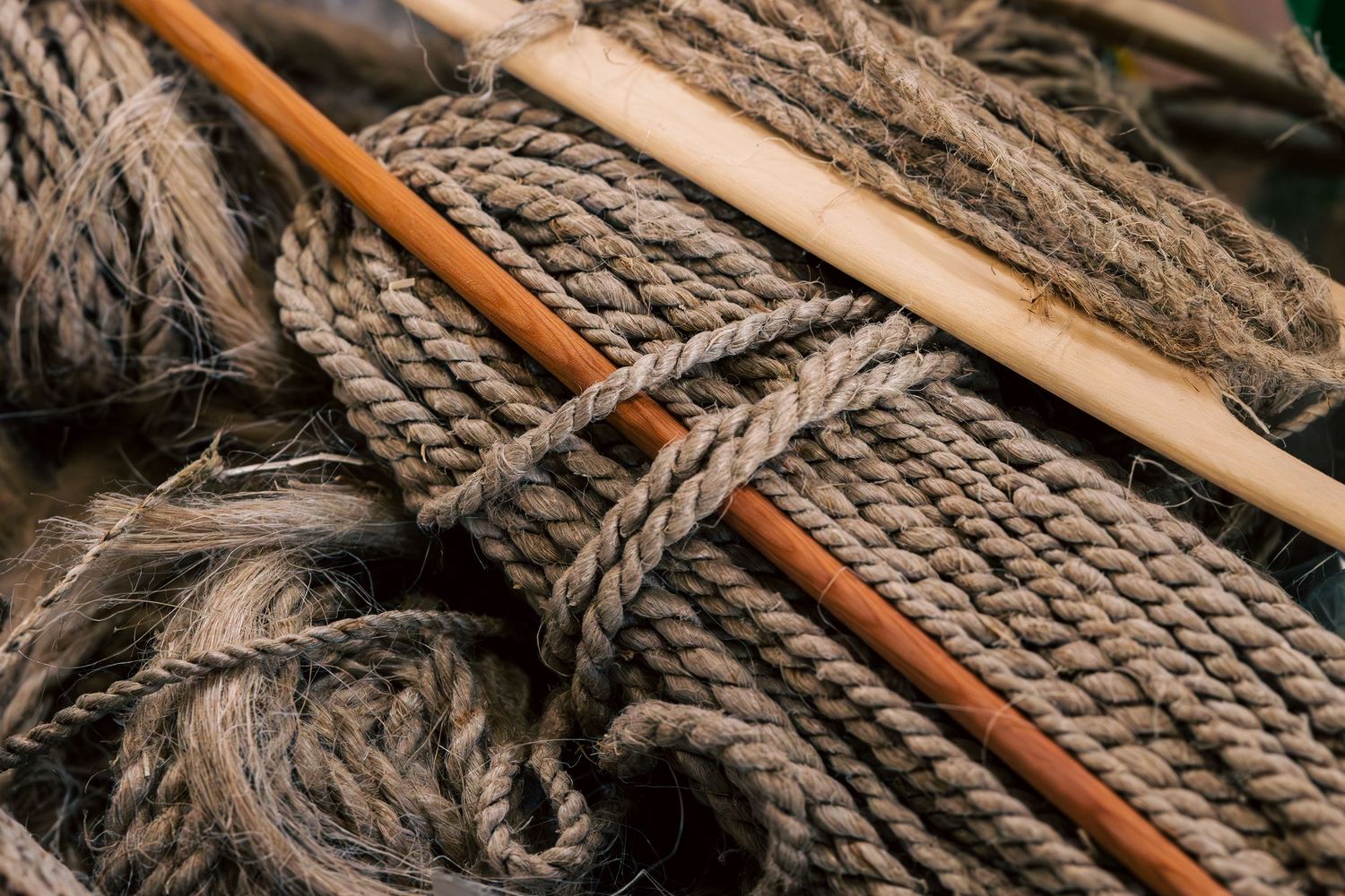 Close-up view of weathered rope and wooden sticks arranged in a rustic composition.