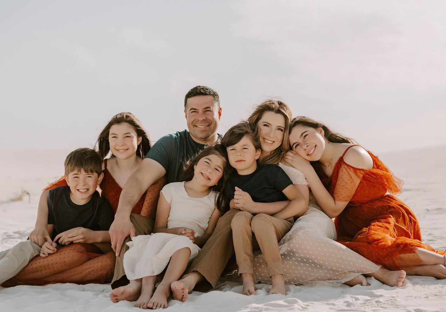 A family cuddled together in White Sands New Mexico for a family photo session