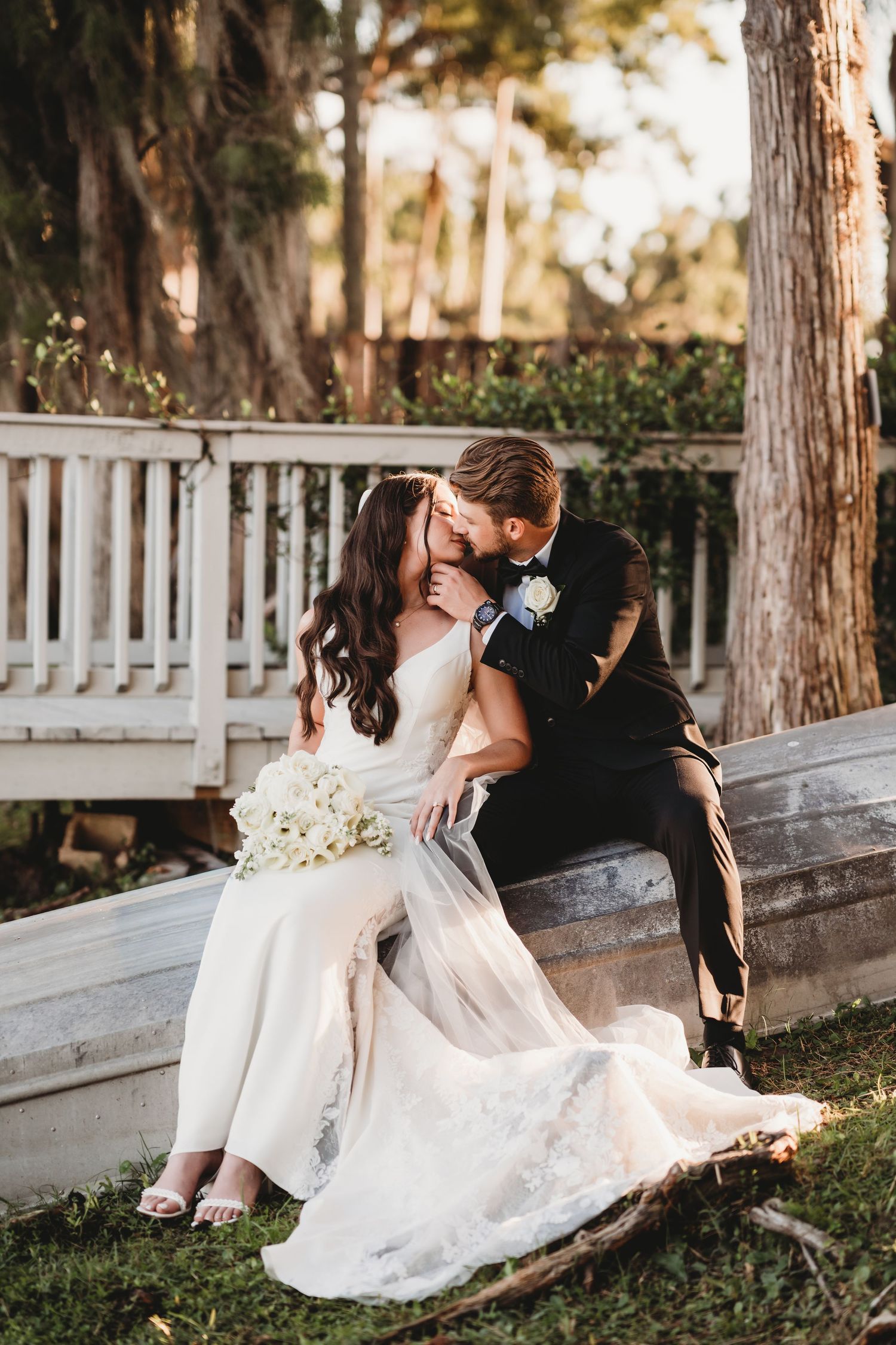 Bride and groom sharing an intimate moment on a boat at Knotted Roots on the Lake