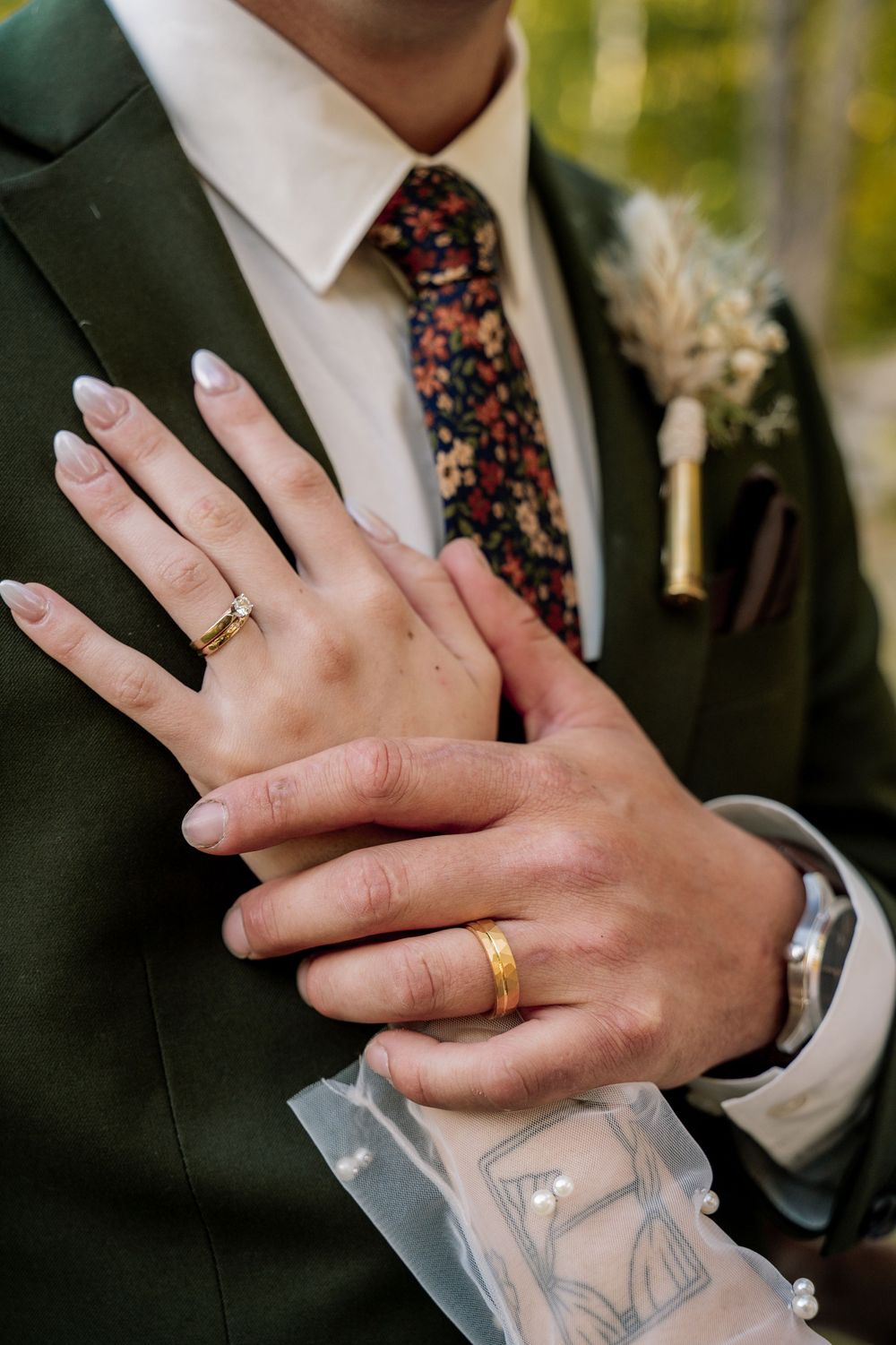 Close-up sequence showing hands wearing wedding rings against formal attire in black and white.