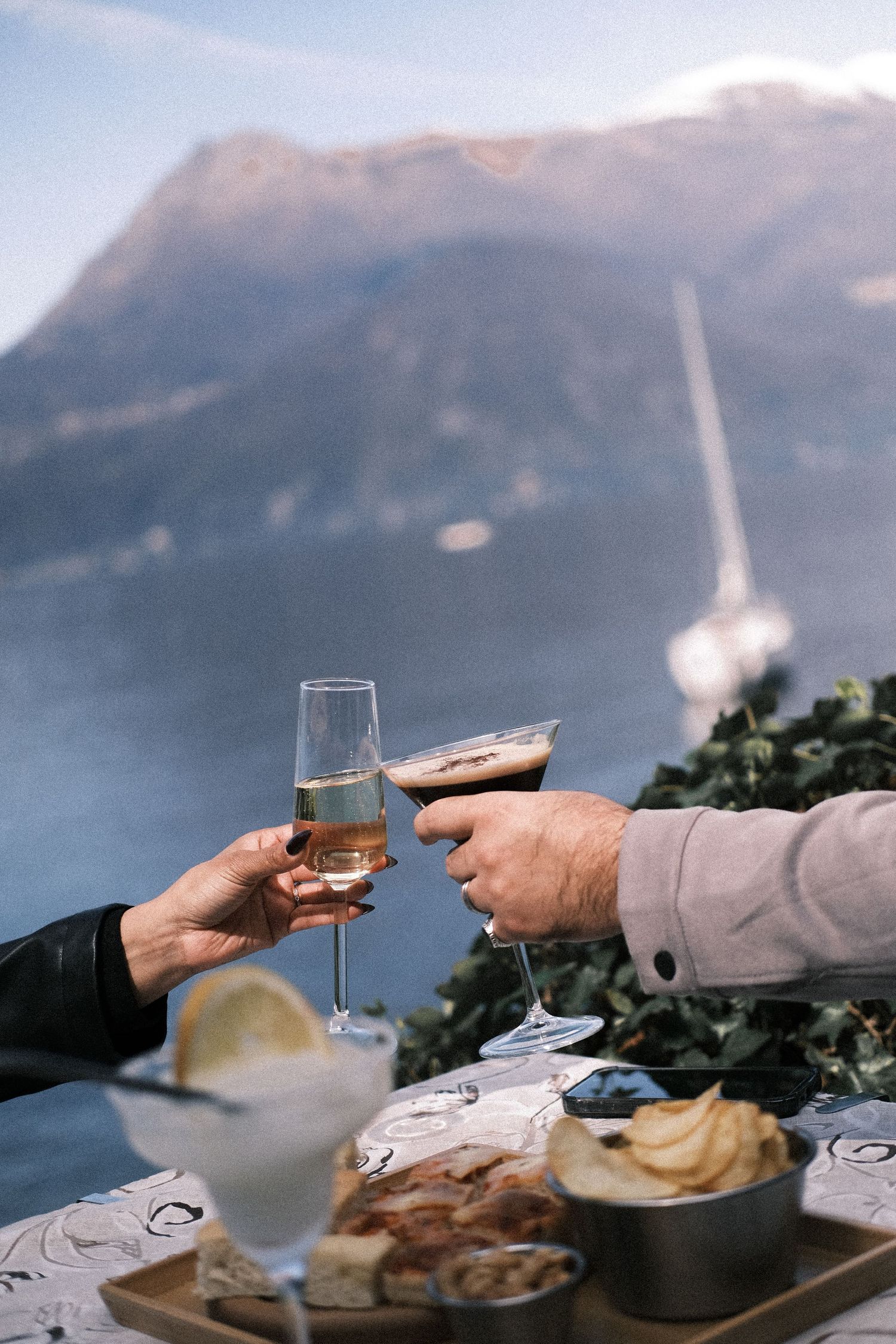 Couple toasting drinks Lake Como sunset romantic view