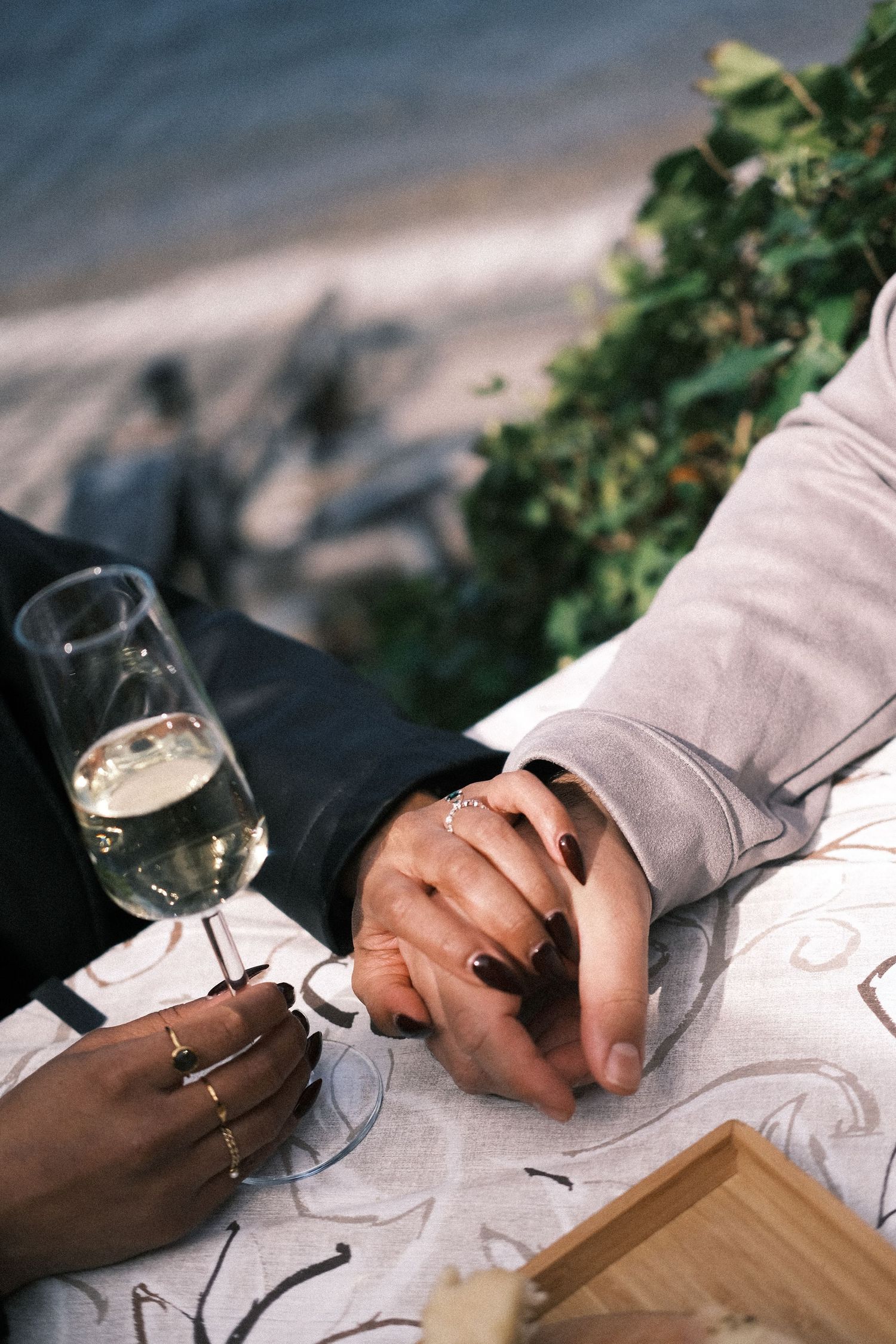 Romantic hands holding wine Lake Como aperitivo